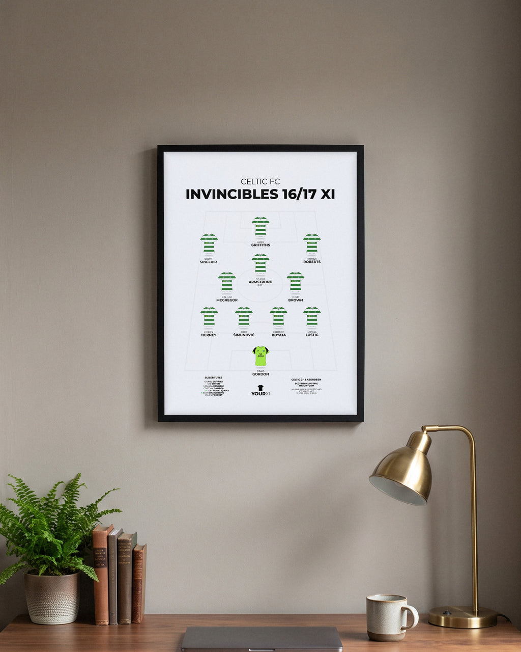 Celtic Invincibles 2016/17 XI framed print, black frame above a desk