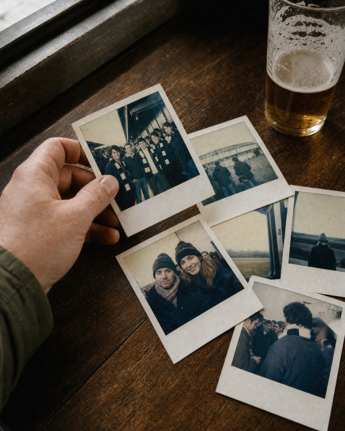 Old away day photos on a pub table