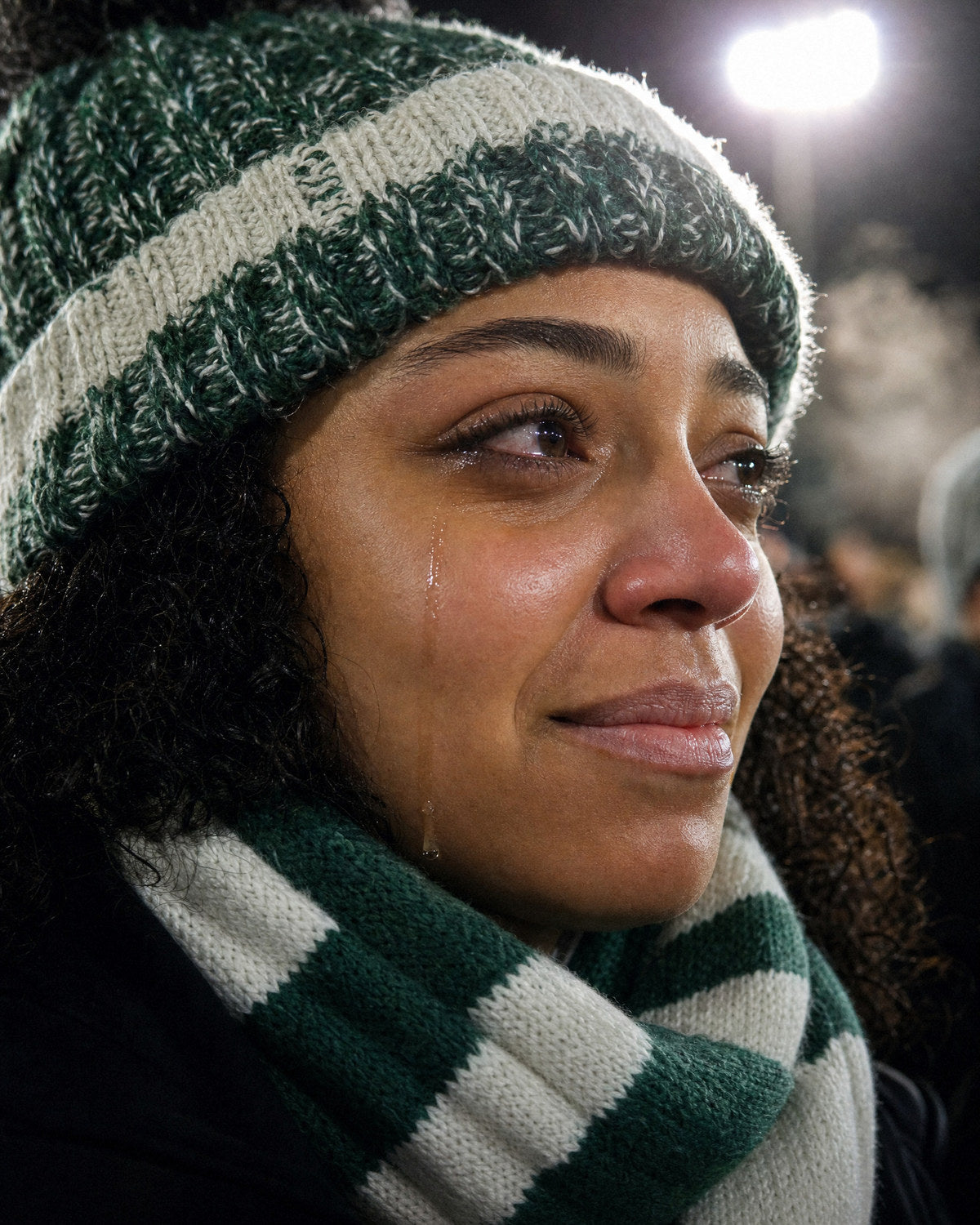 A fan in the stand with a tear on her cheek
